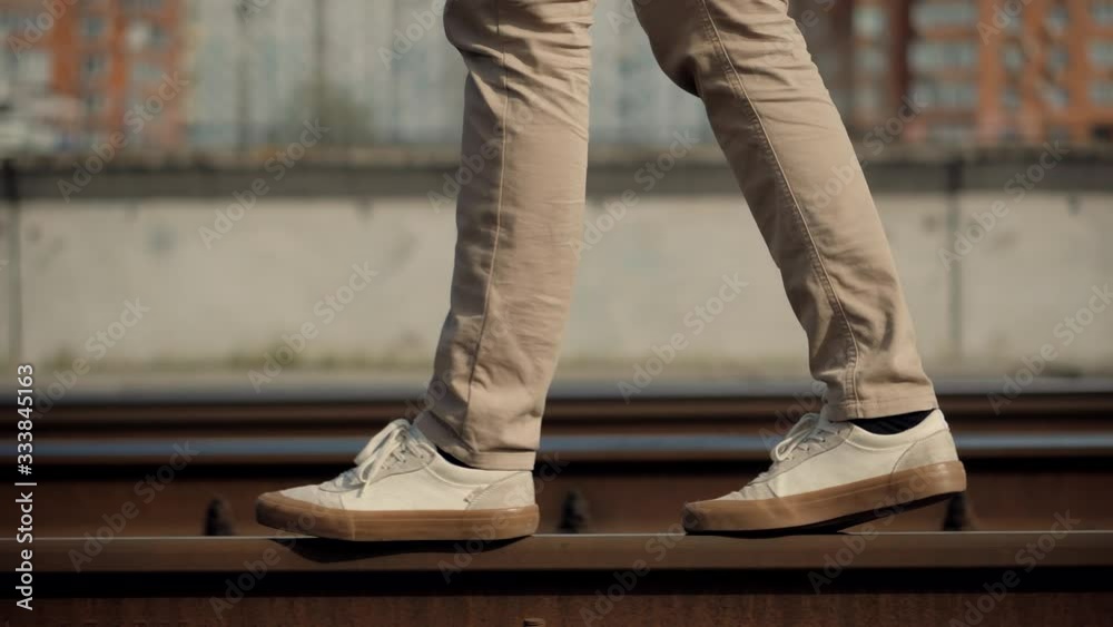 Man Walks To Home On Railroad Tracks After Canceled Public Transport .Tourist Legs Walking On Railway Middle Of Rail.Lonely Businessman Feet In Pants Walking On Rail Road When Train Or Tram Cancelled Man Walks To Home On Railroad Tracks After Canceled Public Transport .Tourist Legs Walking On Railway Middle Of Rail.Lonely Businessman Feet In Pants Walking On Rail Road When Train Or Tram Cancelled