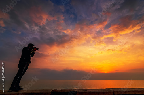 An adventure photographer sightseeing in Khobar sea side sunrise background. City   Khobar  Saudi Arabia.