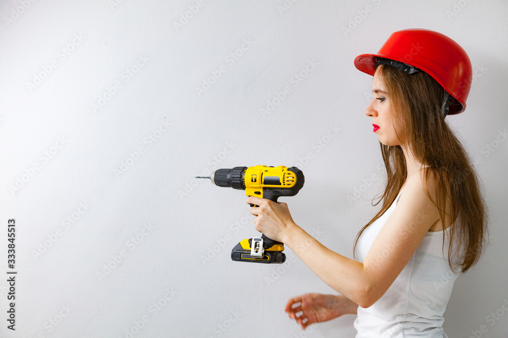 Woman using power driil for work at home Woman using power driil for work at home