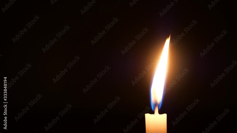 One candle burning alone in the dark. One candle burning alone in the dark.