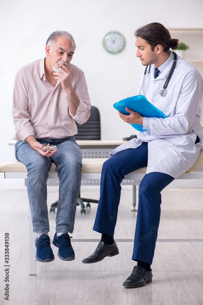 Young male doctor and old patient in antismoking concept Young male doctor and old patient in antismoking concept