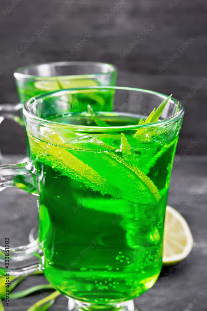 Lemonade Tarragon in two goblets on dark board Lemonade Tarragon in two goblets on dark board
