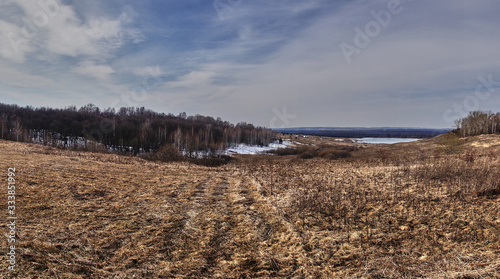 Panorama of the landscape of central Russia.Spring landscape of Russian nature. Fields  forests  hills  plain  open view and horizon  the sky connects to the earth. Russia  the village of Big Boldino