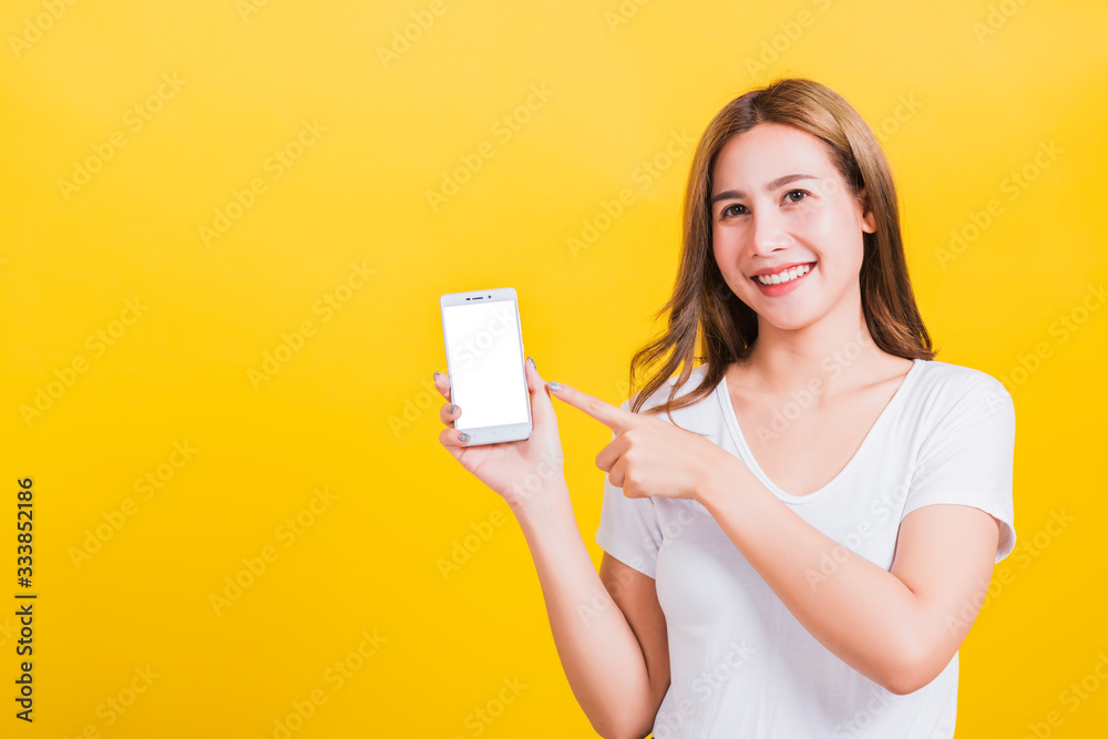 woman smile standing wear t-shirt making finger pointing on smartphone blank screen woman smile standing wear t-shirt making finger pointing on smartphone blank screen