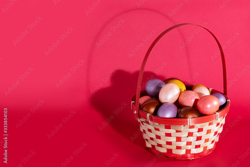 Easter eggs in basket isolated on red Easter eggs in basket isolated on red