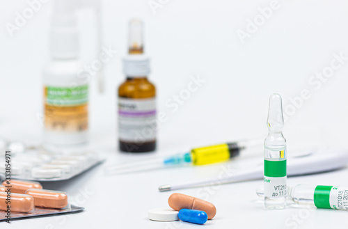 Medicine, capsules in blister, tablets, injection, syringe and needle. Close-up of various drugs