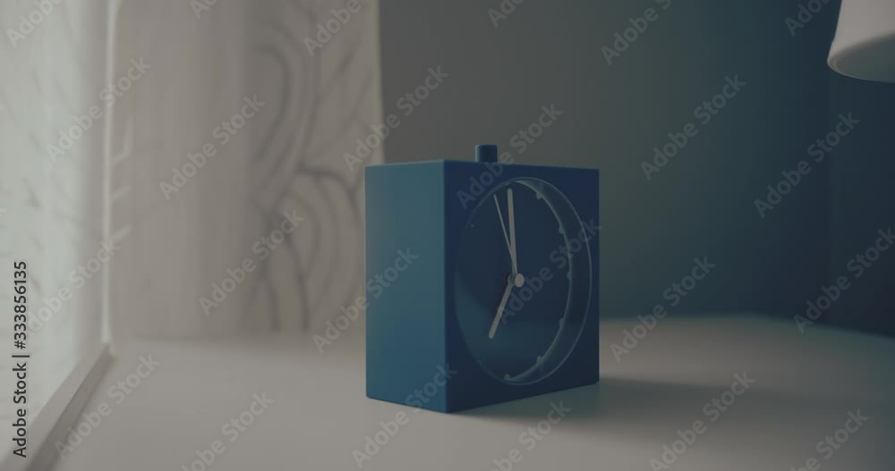 dolly shot of alarm clock turns 7 AM