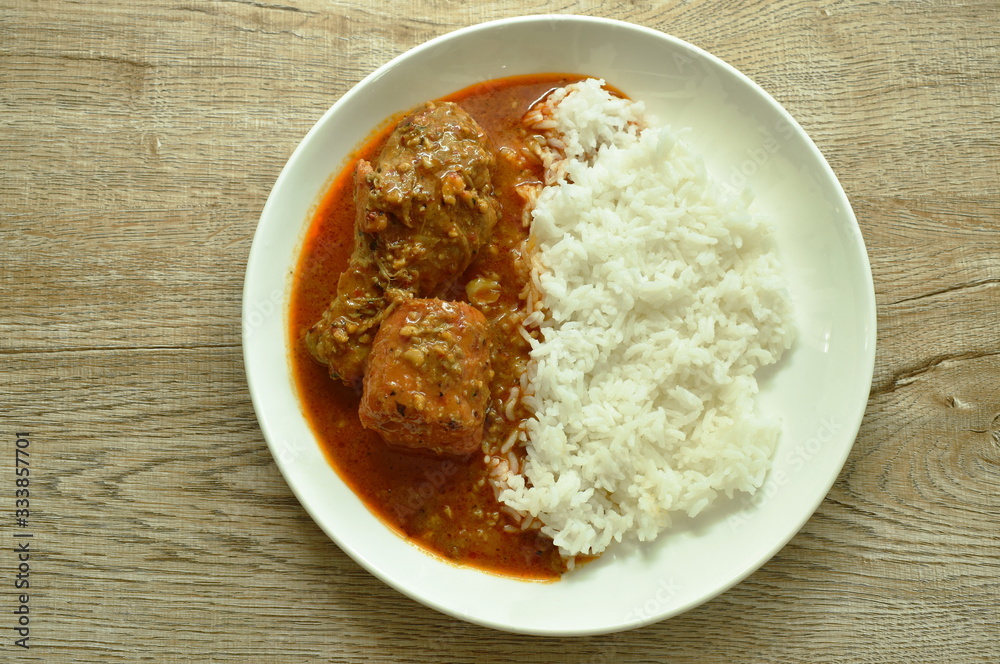 chicken leg spicy and sweet curry or mussaman eat with plain rice on dish chicken leg spicy and sweet curry or mussaman eat with plain rice on dish