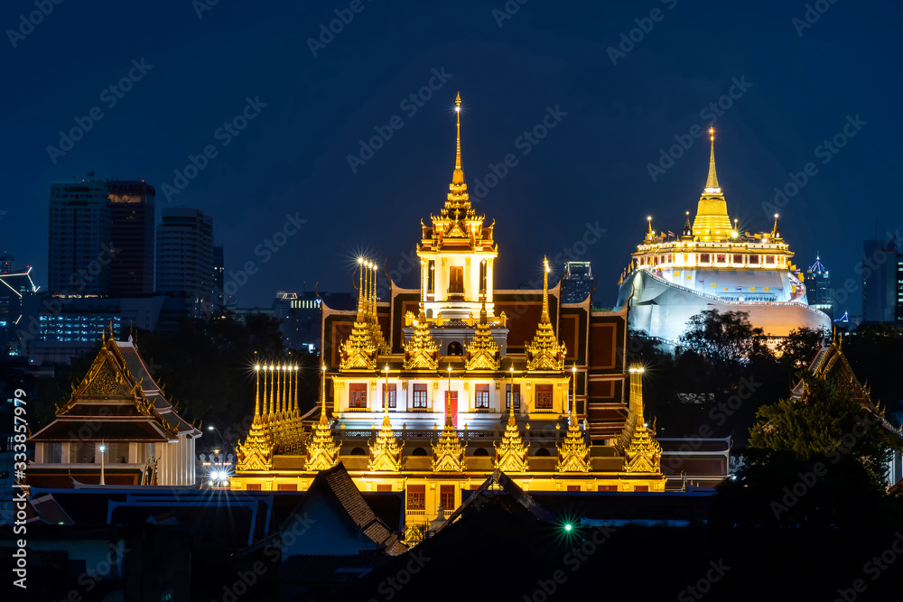 Golden Metal Castle at Wat Ratchanadda (Loha Prasat) and Gloden Mount at Wat Sraket Rajavaravihara at night in Bangkok Thailand.The both famous landmarks Temple and pagoda in Bangkok Thailand.