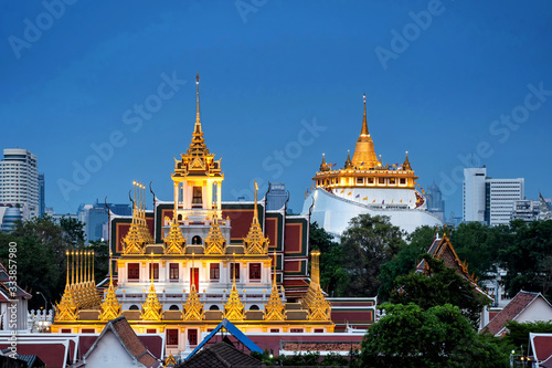 Golden Metal Castle at Wat Ratchanadda  Loha Prasat  and Gloden Mount at Wat Sraket Rajavaravihara at twilight in Bangkok Thailand.The both famous landmarks Temple and pagoda in Bangkok Thailand.