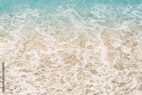 wave of blue ocean on sandy beach. texture Background.