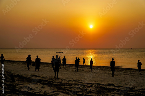 Zanzibar sunset with fisherman silhouettes
