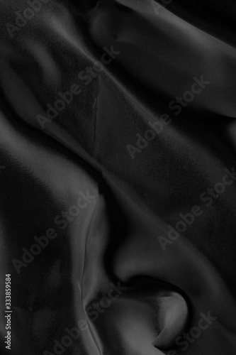 Black fabric texture for background; Abstract black fabric cloth wave or wavy folds texture material for background