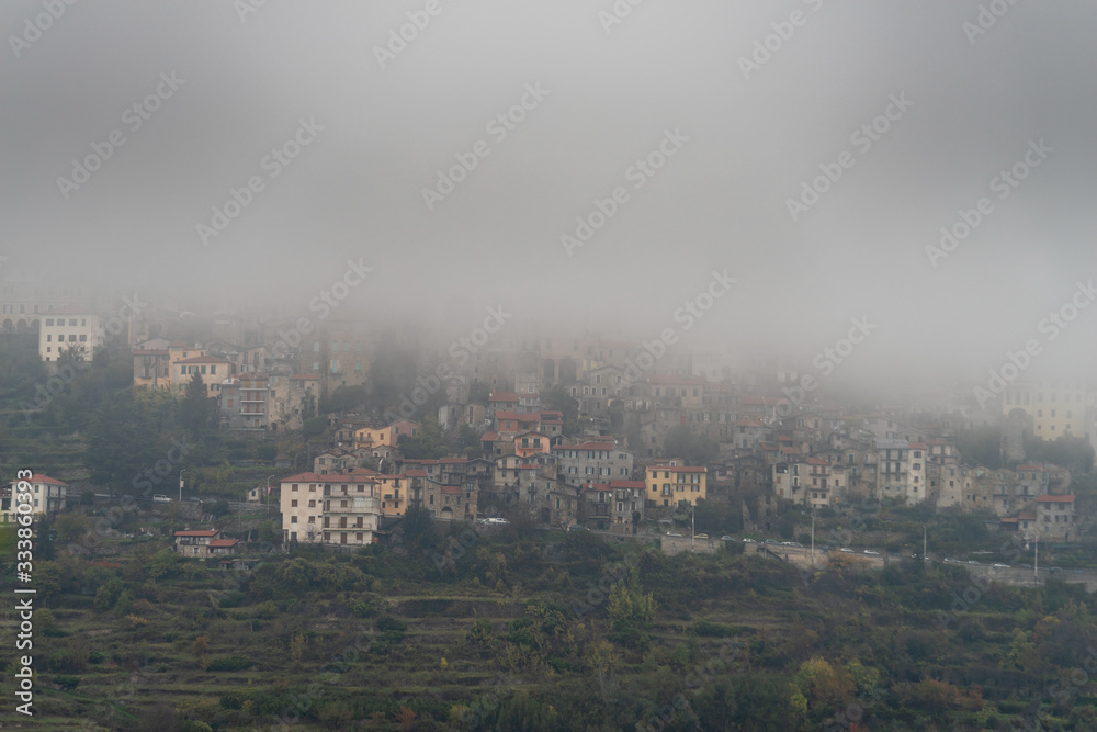 Italy. Triora ancient village covered in dense fog