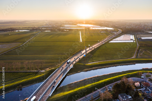 A viaduct bridge crossover a canal of highway A59 during sunrise near Waalwijk, Noord Brabant, Netherlands