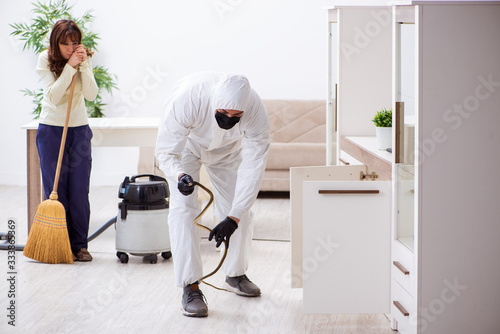 Young male contractor exterminating snakes in the flat