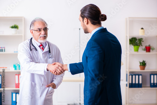 Male doctor and businessman discussing medical project