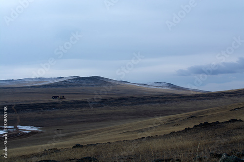 Dried grass field on hill in Siberia, Russia, hill at sunset time