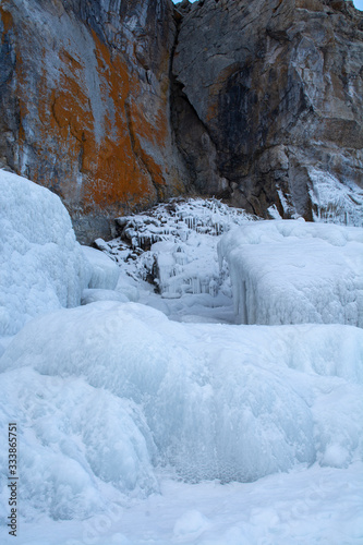Rock cliff with ice stalactite in Lake Baikal, Russia, landscape photography © pomiti