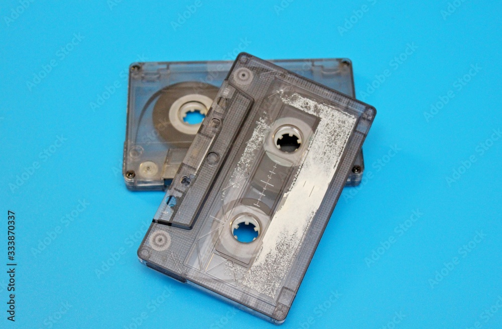 Old audio cassettes are located on a blue background Old audio cassettes are located on a blue background