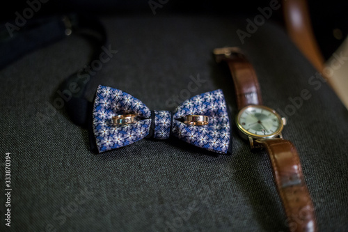 bow tie and watch in a chair