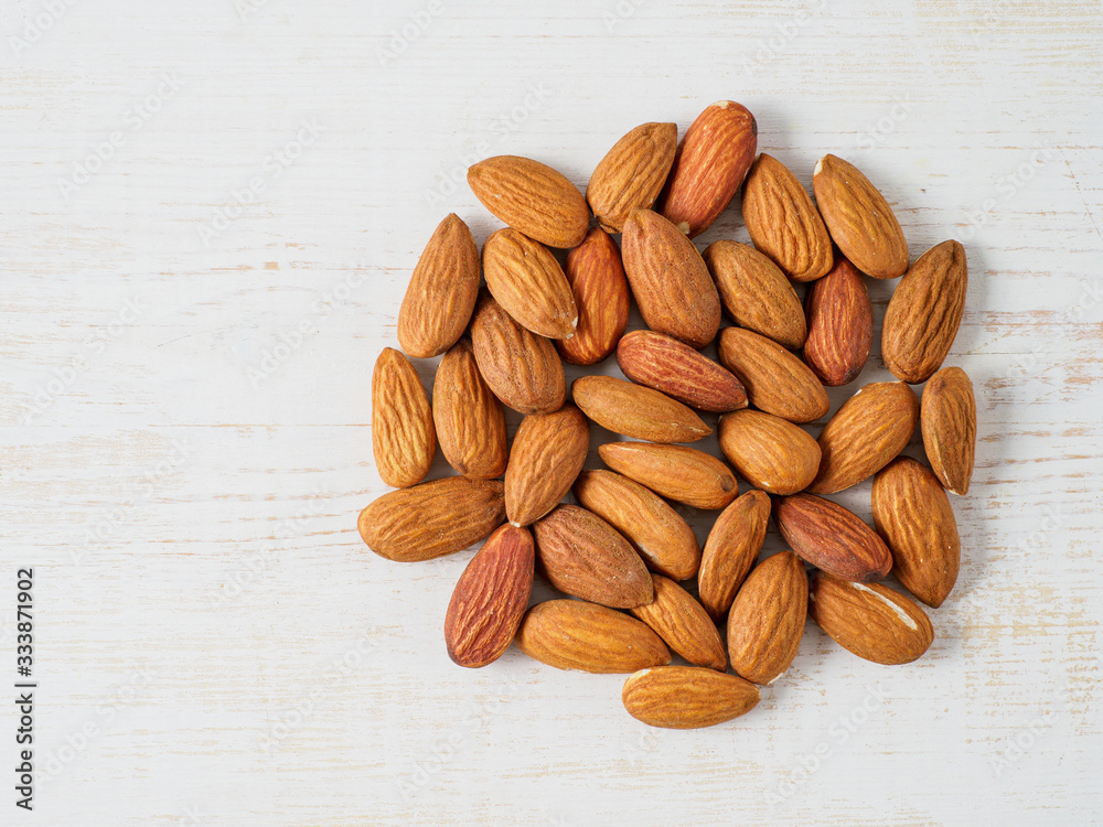 Almond nuts isolated on white wooden background. Almond nuts isolated on white wooden background.
