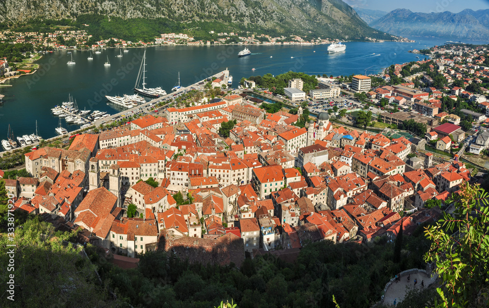 A panoramic view of the Bay of Kotor, cruise port, mountains and the medieval walled old town from the ruins of the Castle of San Giovanni