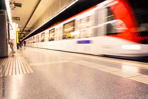 Blurry image of a subway station. Train in motion blur