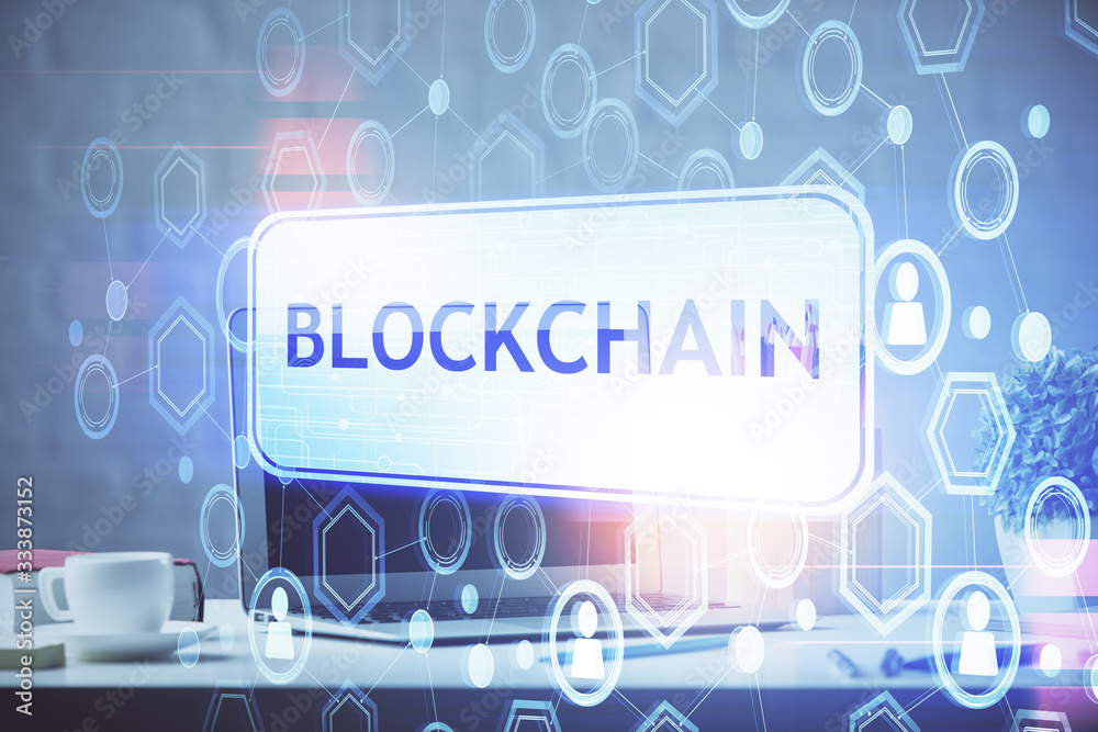 Multi exposure of blockchain and crypto economy theme hologram and table with computer background. Concept of bitcoin cryptocurrency. Multi exposure of blockchain and crypto economy theme hologram and table with computer background. Concept of bitcoin cryptocurrency.
