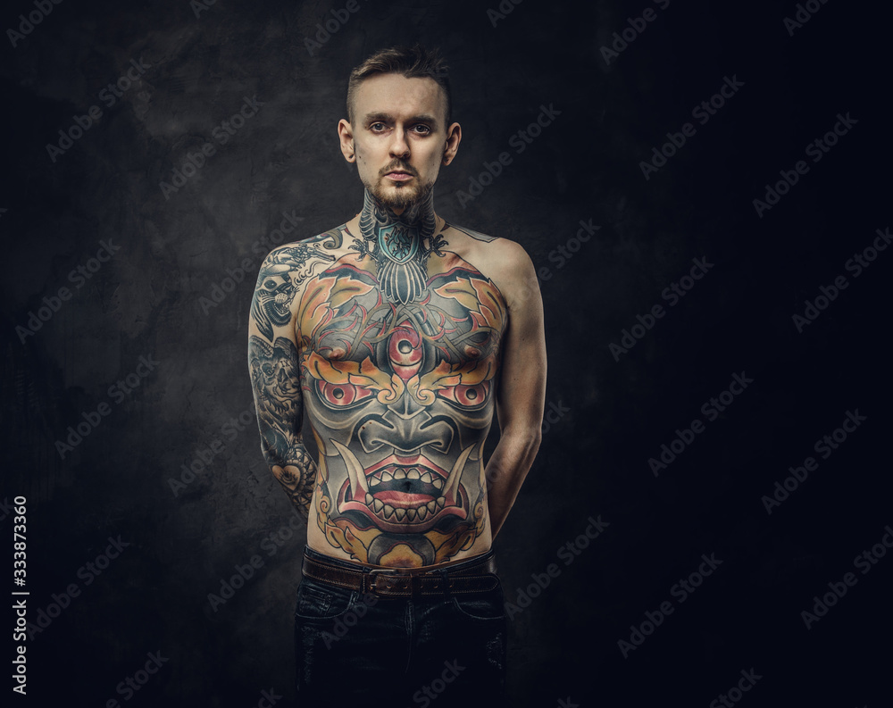 Assertive tattoo artist posing in a dark studio with a half-naked body  wearing jeans, tattooed in a japanese irezumi style, looking cool and  confident. Photos | Adobe Stock