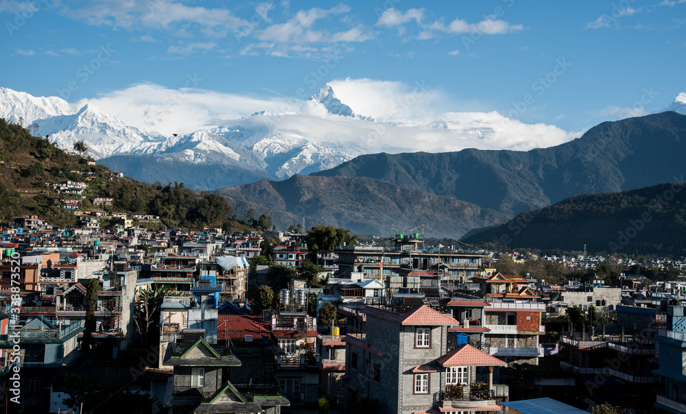 The cityscape of Pokhara with the Annapurna mountain range covered in snow at Nepal Asia