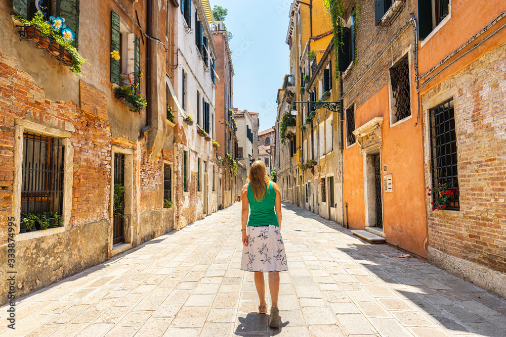 Woman walking on the street. Italy.