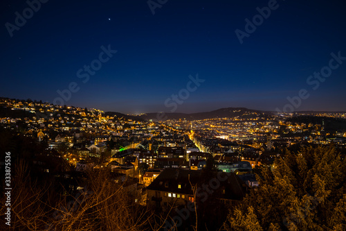 Germany, Famous skyline of stuttgart heslach houses, illuminated by night, aerial view above roofs, houses, streets with starry sky full of stars