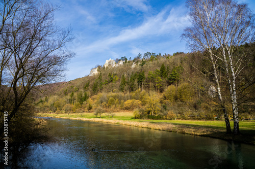 Germany  Beautiful clear water of river blau flowing alongside rocky nature landscape of swabian jura in blaubeuren