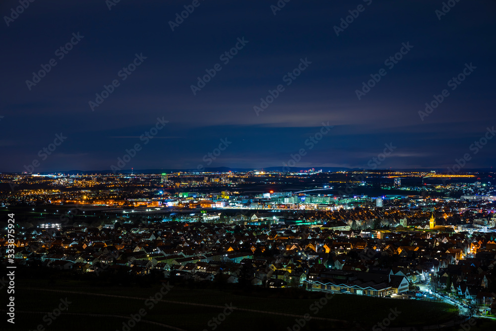 Germany, Aerial panorama view above houses, skyline and streets of fellbach city near stuttgart, illuminated cityscape by night