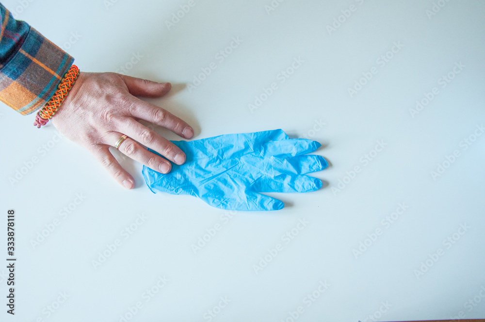 Doctor wears medical gloves. Blue latex medical gloves on a woman's hand, o Doctor wears medical gloves. Blue latex medical gloves on a woman's hand, o