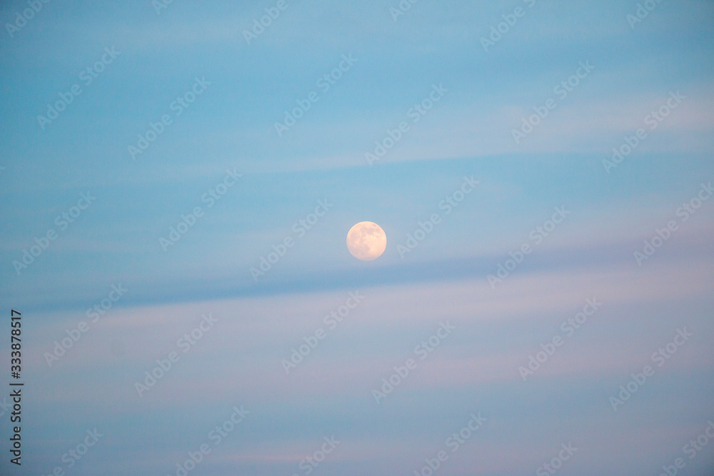 full moon in evening sky with clouds full moon in evening sky with clouds