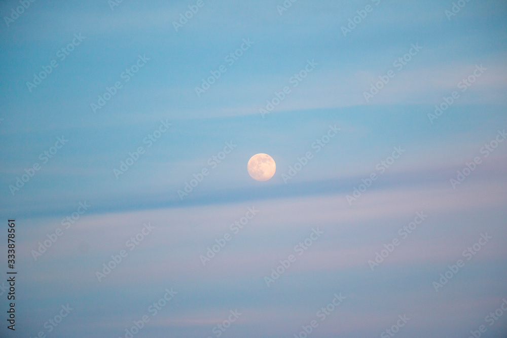 full moon in evening sky with clouds full moon in evening sky with clouds