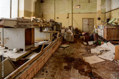 Photo of a garbage dump in an abandoned room of a destroyed factory