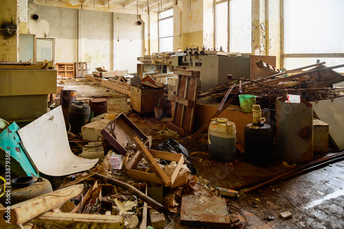 Photo of a garbage dump in a slum in an abandoned factory building photo