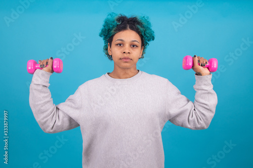 woman doing gymnastics with aerobics weights isolated on color background