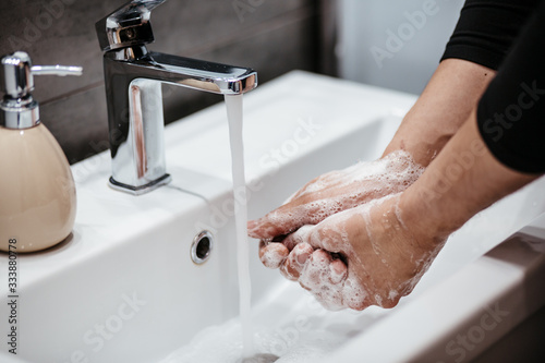 Coronavirus pandemic prevention wash hands with soap warm water and , rubbing nails and fingers washing frequently or using hand sanitizer gel.