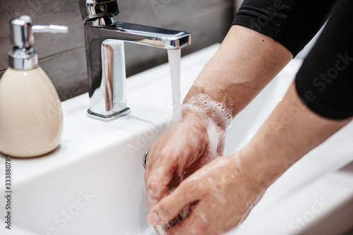 Coronavirus pandemic prevention wash hands with soap warm water and , rubbing nails and fingers washing frequently or using hand sanitizer gel.