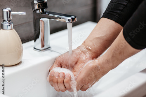 Coronavirus pandemic prevention wash hands with soap warm water and , rubbing nails and fingers washing frequently or using hand sanitizer gel.