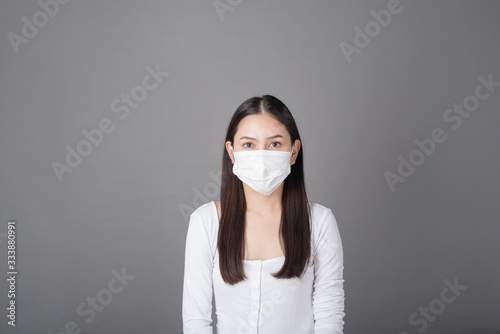 Portrait of woman with surgical mask  in studio, Health care concept © tonefotografia