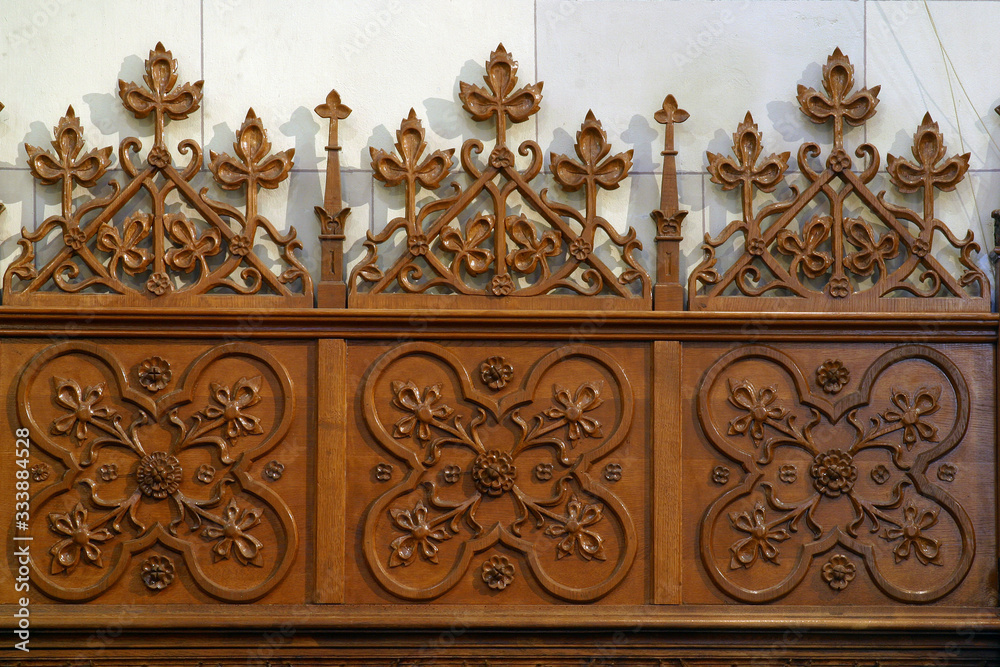 Bench with decorated wood carvings at St. Francis Church in Zagreb, Croatia