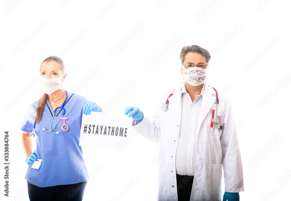 Fototapeta premium Two medical staff hold a sign during Coronavirus COVID-19 pandemic outbread
