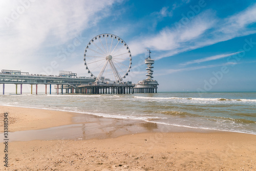 beach of Schevening Netherlands during Spring, The Ferris Wheel The Pier at Scheveningen in Netherlands, Sunny spring day at the beach photo