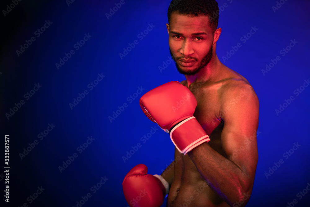 Determined Black Boxer Standing Ready To Fight, Studio Shot Determined Black Boxer Standing Ready To Fight, Studio Shot