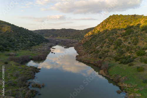 Pulo do Lobo waterfall drone aerial view with river guadiana and beautiful green valley landscape at sunset in Mertola Alentejo, Portugal